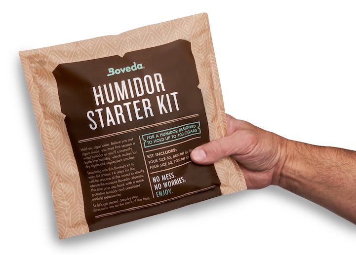 Hand holding a Boveda Starter Kit for Humidors