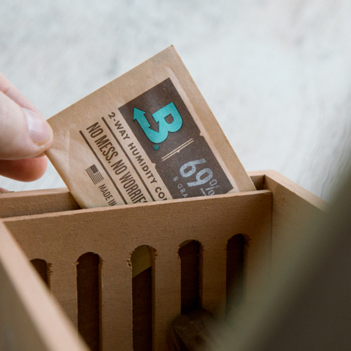 Boveda pack being placed into a humidor