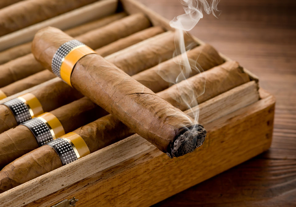 lit cigar on box
