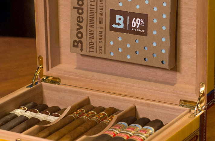 Humidor filled with cigars and a 69% Size 320 Boveda mounted on the inside lid