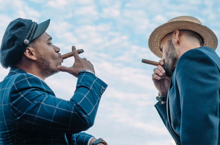 Two men smoking cigars