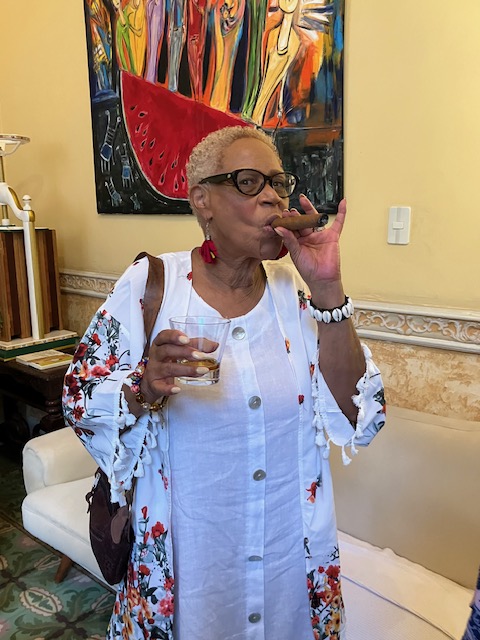 Woman smoking a Cuban  cigar in a Havana cigar lounge.