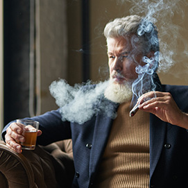 A man smoking and enjoying a cigar
